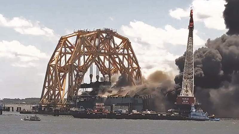 Plumes of smoke, flames pouring from shipwreck